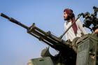 A Taliban soldier stands next to an anti-aircraft gun while on lookout for Pakistani fighter jets, in Khost province