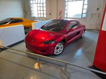 O čtyři roky dříve zase Bertone vzal Porsche 911 Carrera (generace 964) a postavil na něm prototyp čtyřmístného sedanu Karisma. Jediný pár dveří se otevírá směrem vzhůru, podobně jako u staršího konceptu Lamborghini Marzal.