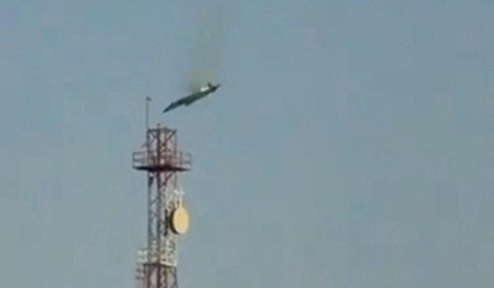 A burning aircraft falls from the sky in Al Jahra, in this still image obtained from social media video