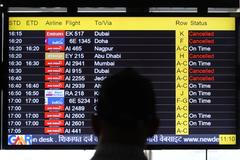 A man views a screen displaying flight information at the Indira Gandhi International airport in New Delhi