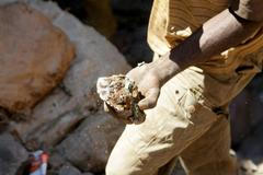 FILE PHOTO: An artisanal miner carries raw ore at Tilwizembe outside of Kolwezi