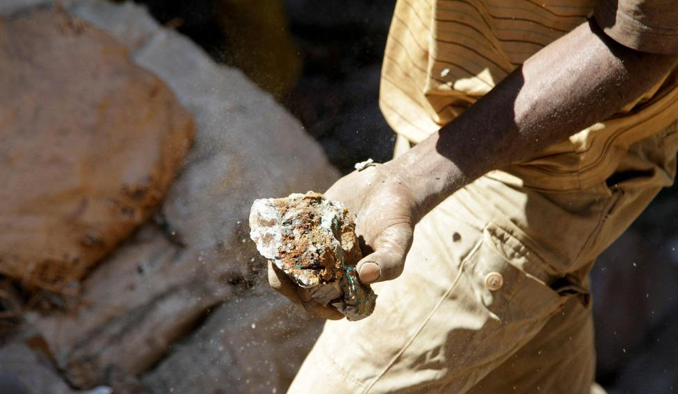 FILE PHOTO: An artisanal miner carries raw ore at Tilwizembe outside of Kolwezi