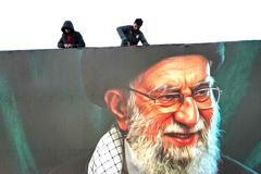 Dělníci instalují obří billboard s tváří ajatolláha Chameneího poté, co ho o víkendu izraelské síly zabily během leteckého útoku na Teherán