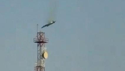 A burning aircraft falls from the sky in Al Jahra, in this still image obtained from social media video