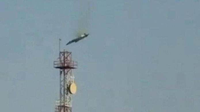 A burning aircraft falls from the sky in Al Jahra, in this still image obtained from social media video