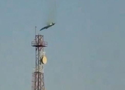 A burning aircraft falls from the sky in Al Jahra, in this still image obtained from social media video