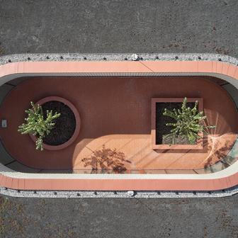 V krajině se objevuje jako dlouhá, nízká červená linie položená na zeleném polštáři bývalého sadu. 