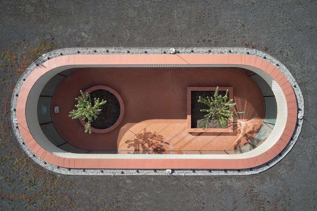 V krajině se objevuje jako dlouhá, nízká červená linie položená na zeleném polštáři bývalého sadu. 