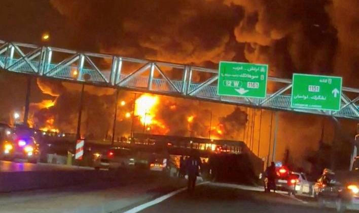 Fire burns and smoke rises from Aqdasieh Oil Depot in Tehran