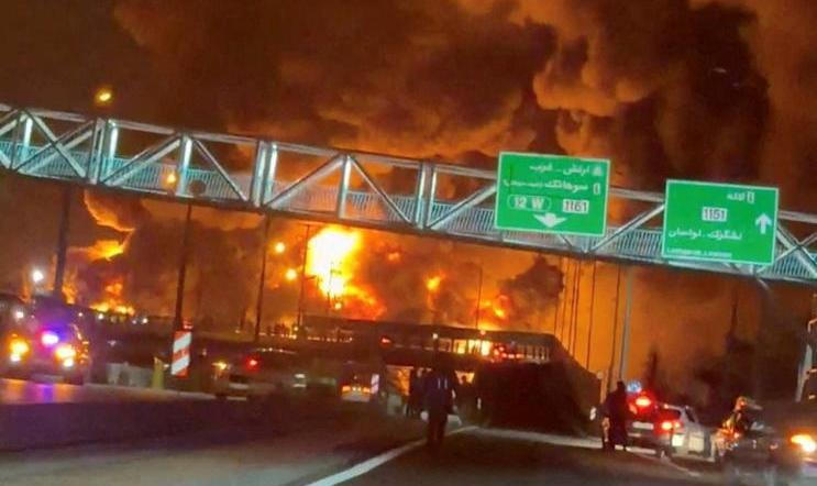 Fire burns and smoke rises from Aqdasieh Oil Depot in Tehran