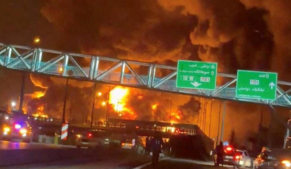 Fire burns and smoke rises from Aqdasieh Oil Depot in Tehran