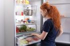 Hungry,Woman,Looking,For,Food,In,Kitchen,At,Home