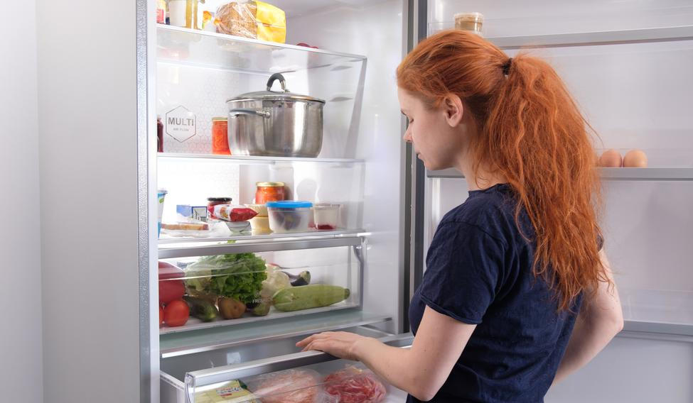 Hungry,Woman,Looking,For,Food,In,Kitchen,At,Home