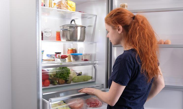 Hungry,Woman,Looking,For,Food,In,Kitchen,At,Home