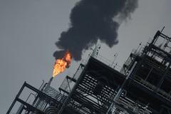 A flame rises from a gas flare at the Dangote refinery refinery in Lagos, Nigeria