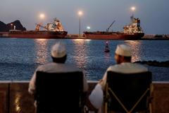 Galaxy Globe bulk carrier and Luojiashan tanker sit anchored in Muscat
