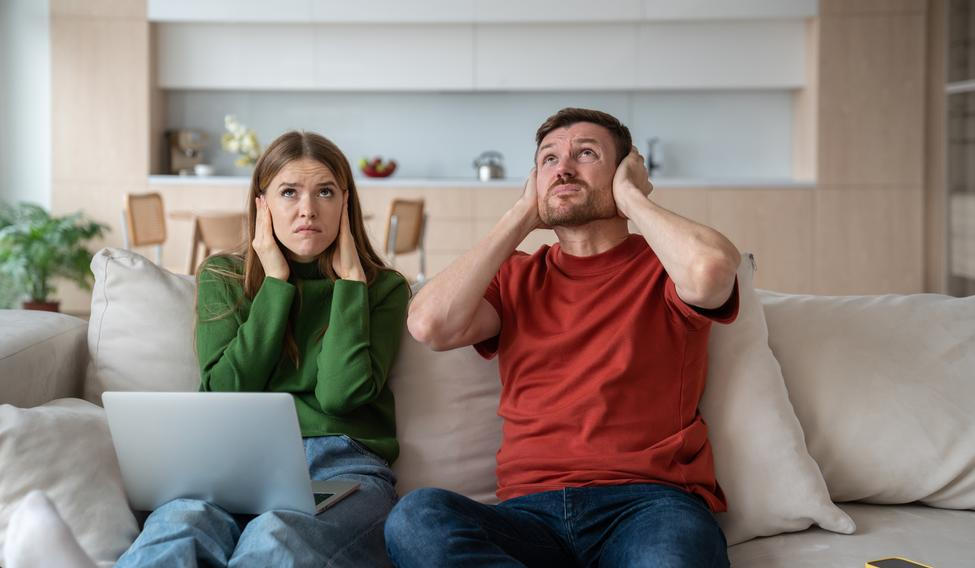 Annoyed,Unhappy,Couple,Sitting,On,Sofa,With,Vexed,Face,Expression,
