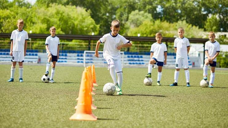 Team of Boys Training for Football Game