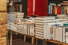 Stacks,Of,Hardcover,Books,Displayed,On,Bookstore,Tables,During,Busy