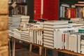 Stacks,Of,Hardcover,Books,Displayed,On,Bookstore,Tables,During,Busy