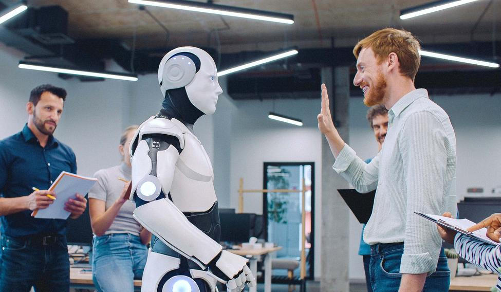 Multi-ethnic,Group,Of,People,Gathering,Together,To,Watch,Humanoid,Robot