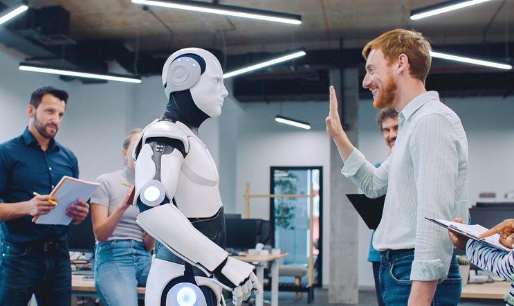 Multi-ethnic,Group,Of,People,Gathering,Together,To,Watch,Humanoid,Robot