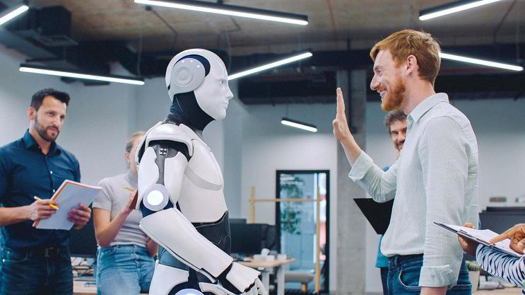 Multi-ethnic,Group,Of,People,Gathering,Together,To,Watch,Humanoid,Robot