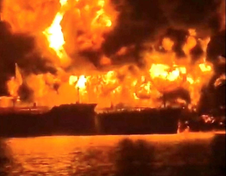 A ship burns, after Iranian explosive-laden boats appear to have attacked two fuel tankers in Iraqi waters setting them ablaze