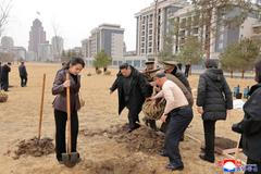 North Korean leader Kim Jong Un and his daughter Kim Ju Ae plant a tree at Saebyeol Street Pond Park, in Pyongyang