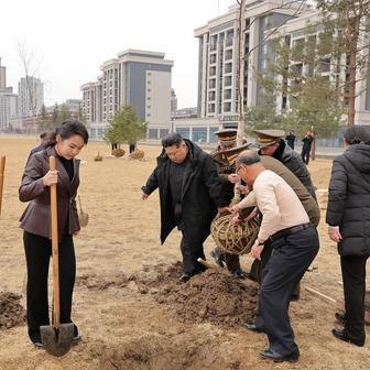 North Korean leader Kim Jong Un and his daughter Kim Ju Ae plant a tree at Saebyeol Street Pond Park, in Pyongyang