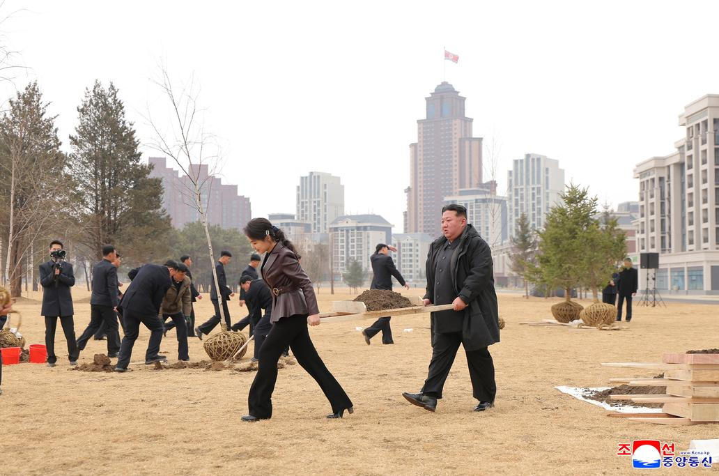 North Korean leader Kim Jong Un and his daughter Kim Ju Ae plant a tree at Saebyeol Street Pond Park, in Pyongyang