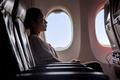 Woman,Sitting,In,A,Flying,Aircraft,And,Watching,The,Monitor.