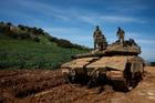 Israeli soldiers stand on a tank on the Israeli side of the border with Lebanon, amid escalation between Hezbollah and Israel