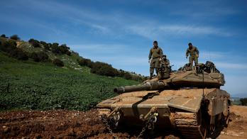 Israeli soldiers stand on a tank on the Israeli side of the border with Lebanon, amid escalation between Hezbollah and Israel