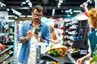Man,Pays,With,His,Smartphone,At,A,Busy,Supermarket,Checkout,