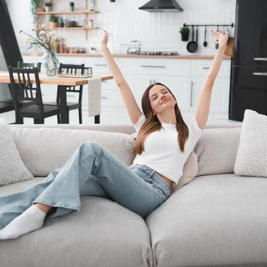 Apartment,,Woman,And,Happy,In,Portrait,On,Sofa,With,Peaceful,