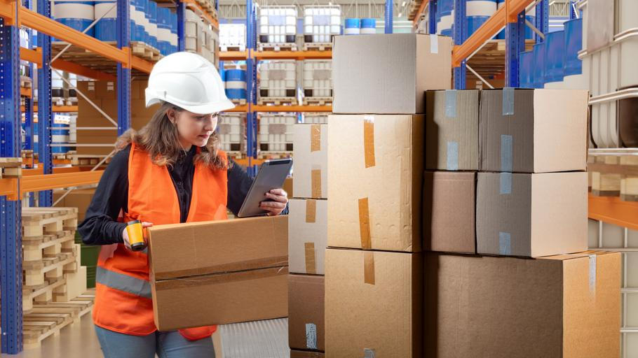 Female,Warehouse,Worker,In,Safety,Gear,Checks,Inventory,Using,A
