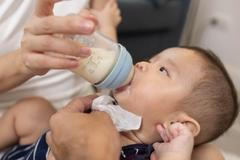 The,Baby,Is,Drinking,Milk,From,A,Bottle.,The,Baby