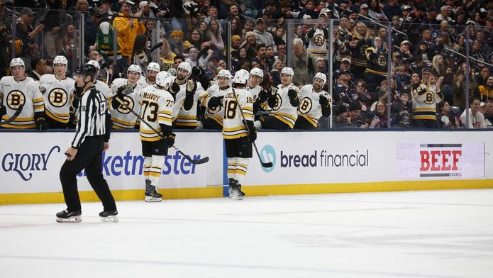 Pavel Zacha (18) slaví se spoluhráči z Bostonu svoji branku v duelu NHL s Columbusem