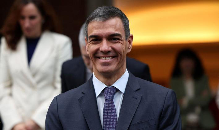 FILE PHOTO: Spain's PM Sanchez poses with members of the government for a family photo before their last cabinet meeting of the year at Moncloa Palace in Madrid
