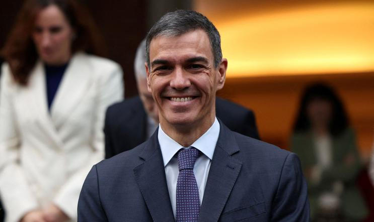 FILE PHOTO: Spain's PM Sanchez poses with members of the government for a family photo before their last cabinet meeting of the year at Moncloa Palace in Madrid
