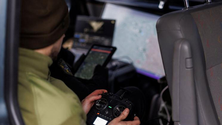 Ukrainian servicemen fly with an FPV interceptor drone during their combat shift in Kharkiv region