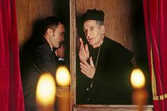 Businessman,In,Confessional,With,Priest