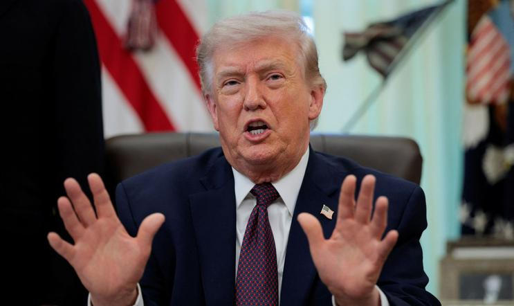 U.S. President Trump signs an executive order in the Oval Office of the White House