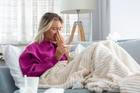 Young Woman Caught Cold Or Flu Illness. Portrait Of Unhealthy Girl blowing her nose
