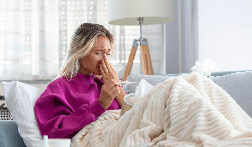 Young Woman Caught Cold Or Flu Illness. Portrait Of Unhealthy Girl blowing her nose
