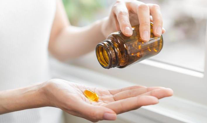 Dietary,Supplement,Concept,,Happy,Asian,Young,Woman,Hand,Holding,Fish
