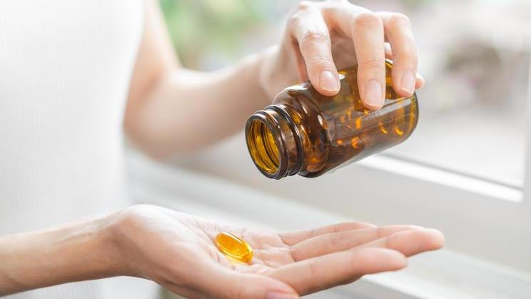 Dietary,Supplement,Concept,,Happy,Asian,Young,Woman,Hand,Holding,Fish