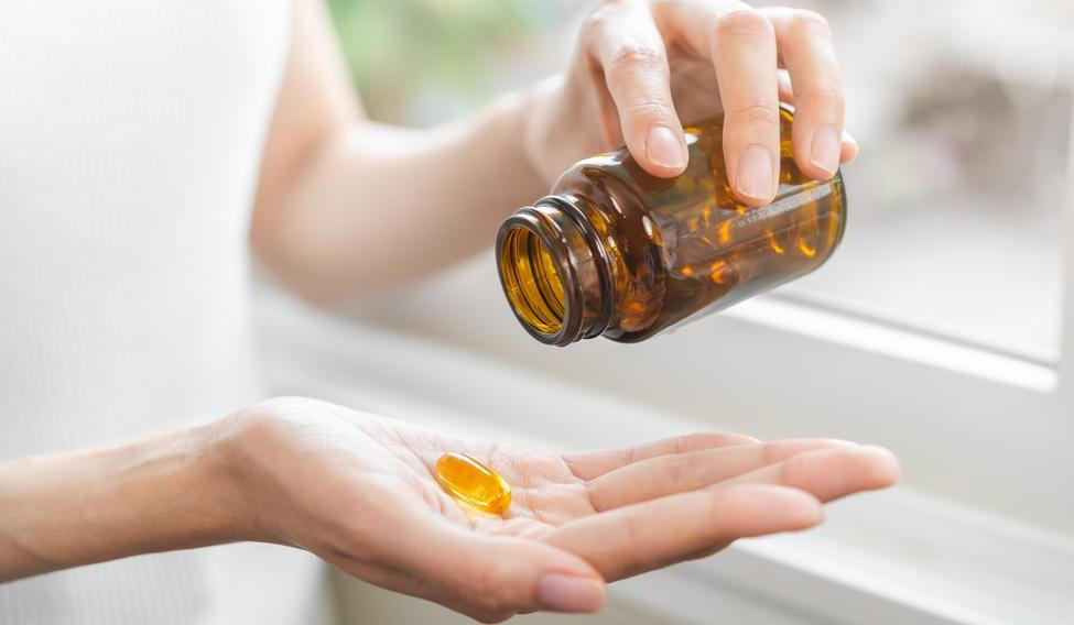 Dietary,Supplement,Concept,,Happy,Asian,Young,Woman,Hand,Holding,Fish