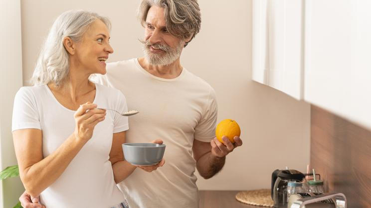 Lady,With,A,Spoon,Of,Porridge,Smiling,At,Her,Husband